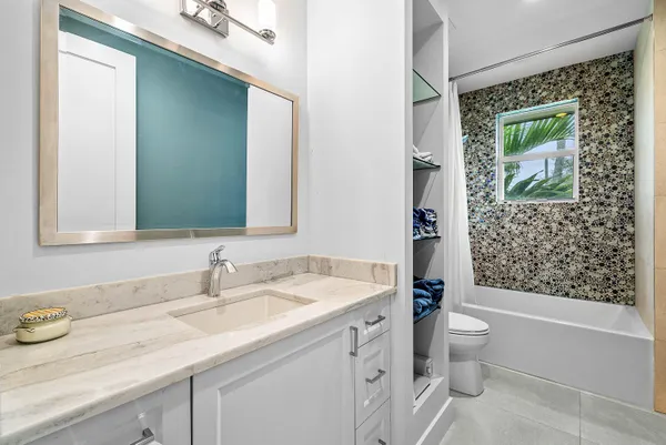 a white bath tub sitting next to a white sink