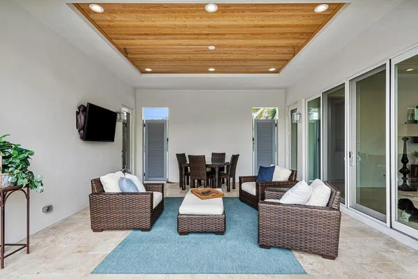 a view of a house with swimming pool and sitting area
