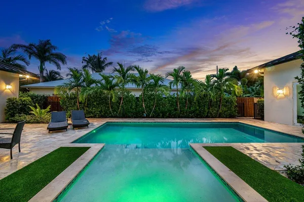 a bathroom with a granite countertop sink a toilet and shower