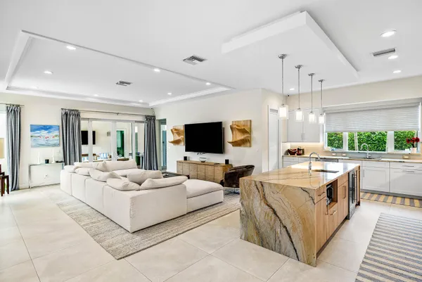 a kitchen with kitchen island granite countertop a sink stainless steel appliances and cabinets