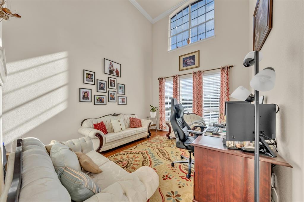 2244 Condor Street Grand Prairie, TX 75052 - Photo 5 of 37 a living room with furniture gym equipment and a flat screen tv