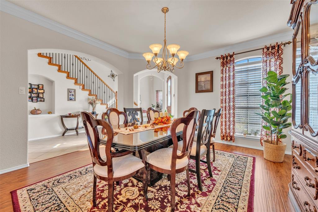 2244 Condor Street Grand Prairie, TX 75052 - Photo 7 of 37 a dining room with furniture potted plants and wooden floor