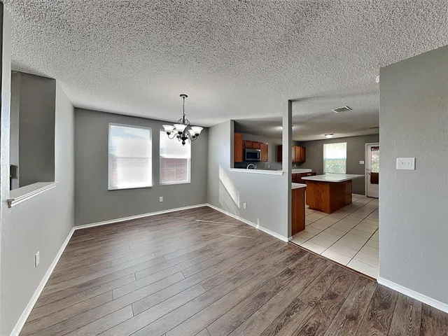 a view of a kitchen cabinets and wooden floor