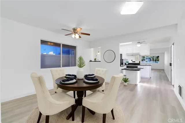 a view of a dining room with furniture and chandelier