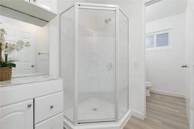 a bathroom with a shower and a mirror