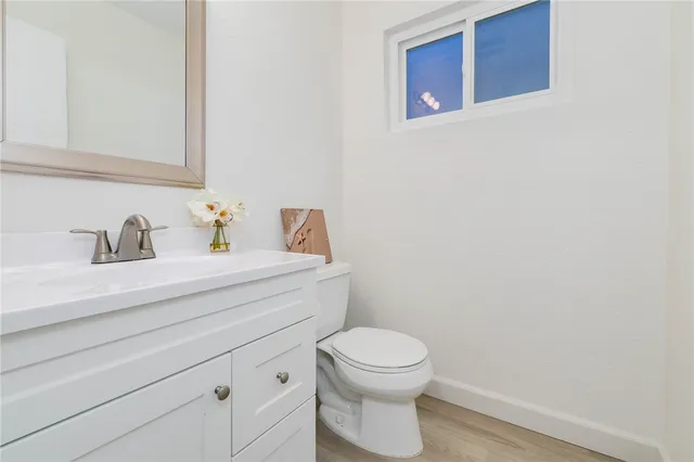 a bathroom with a sink a toilet and vanity