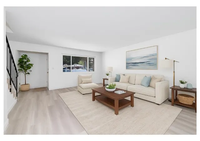 a living room with furniture and a potted plant