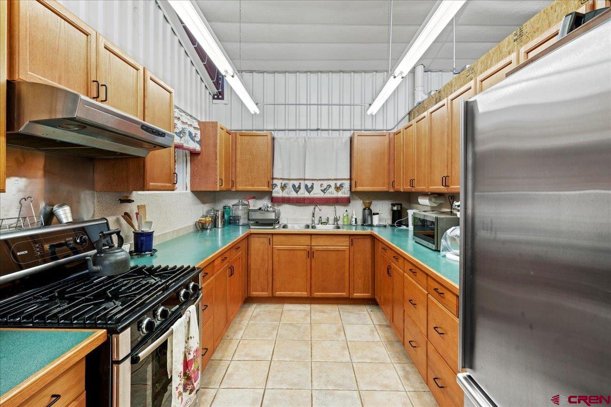 15773 6000th Road Montrose, CO 81403 - Photo 24 of 35 a kitchen with stainless steel appliances granite countertop a stove and a sink