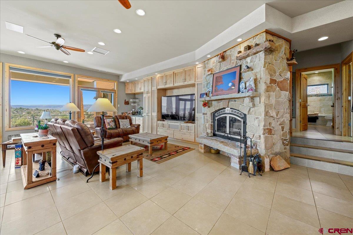 15773 6000th Road Montrose, CO 81403 - Photo 4 of 35 a living room with furniture a fireplace and a flat screen tv