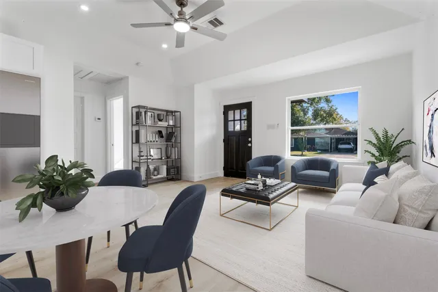 a living room with furniture and a potted plant