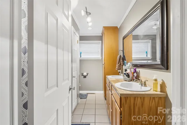 a spacious bathroom with a sink a mirror and a shower