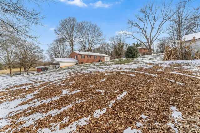 a view of a yard with snow on the road