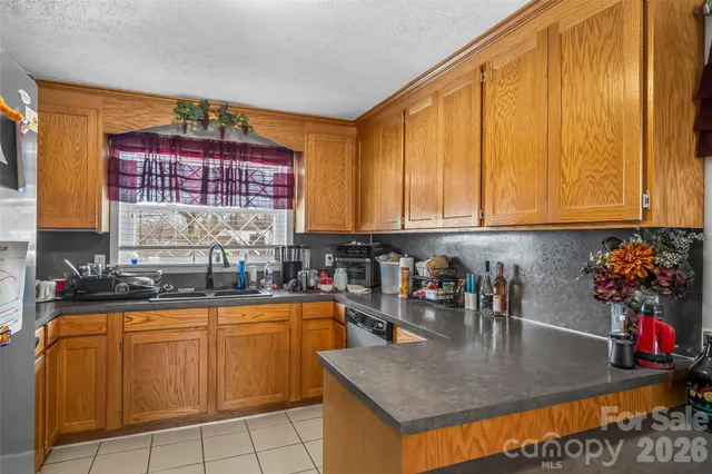 a kitchen with sink cabinets and window