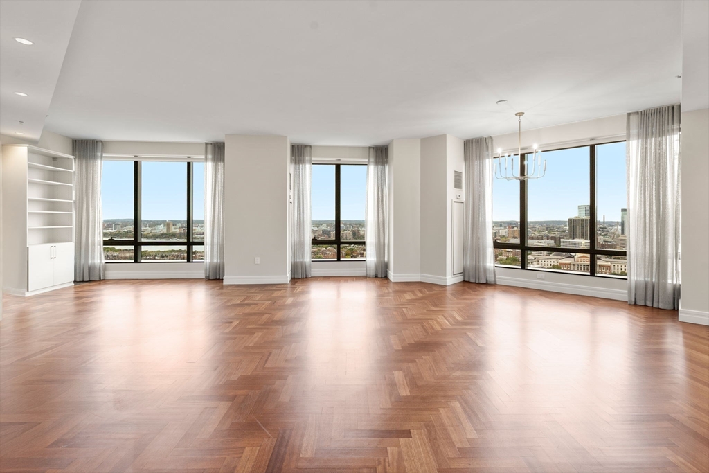 1 Avery Street, Unit 33A Boston, MA 02111 - Photo 1 of 29 an empty room with wooden floor and windows