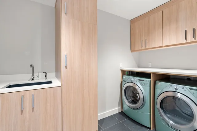 a utility room with sink dryer and washer