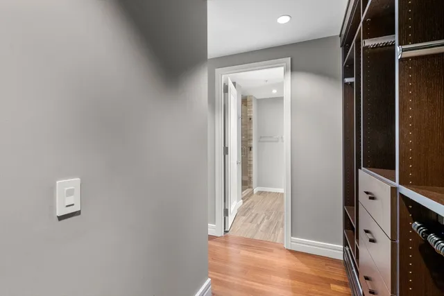 a view of a hallway with wooden floor