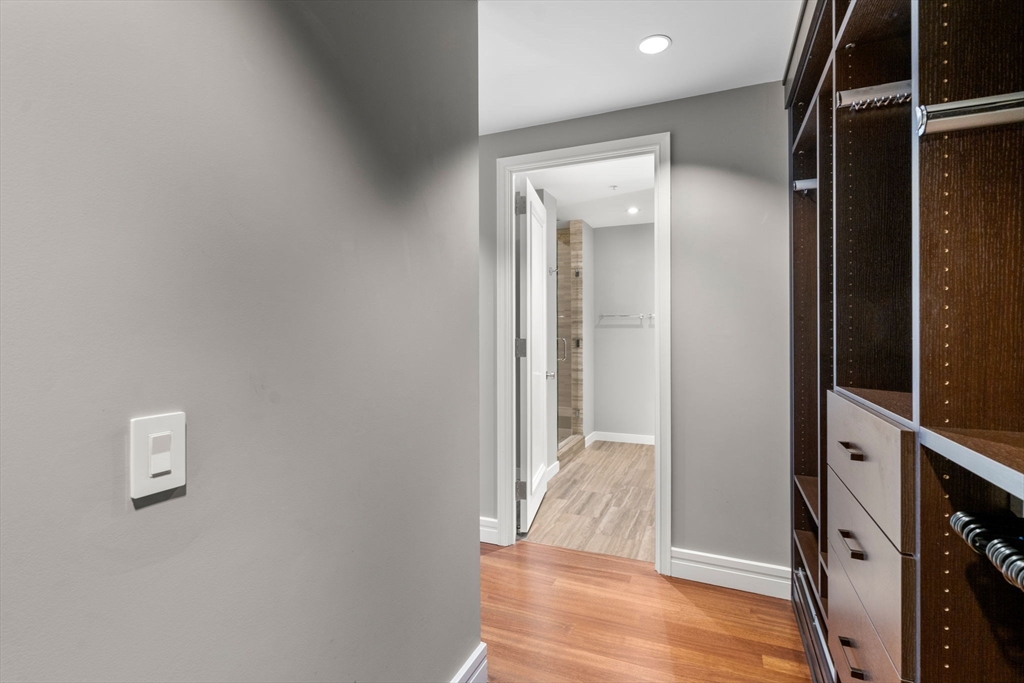 1 Avery Street, Unit 33A Boston, MA 02111 - Photo 17 of 29 a view of a hallway with wooden floor