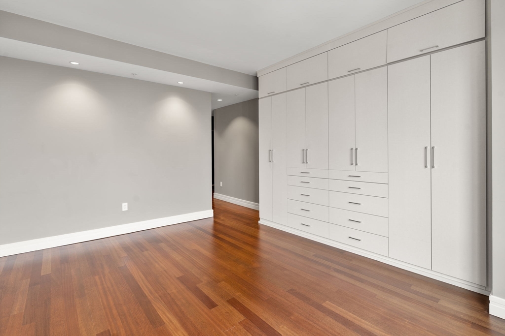 1 Avery Street, Unit 33A Boston, MA 02111 - Photo 23 of 29 a view of an empty room with wooden floor