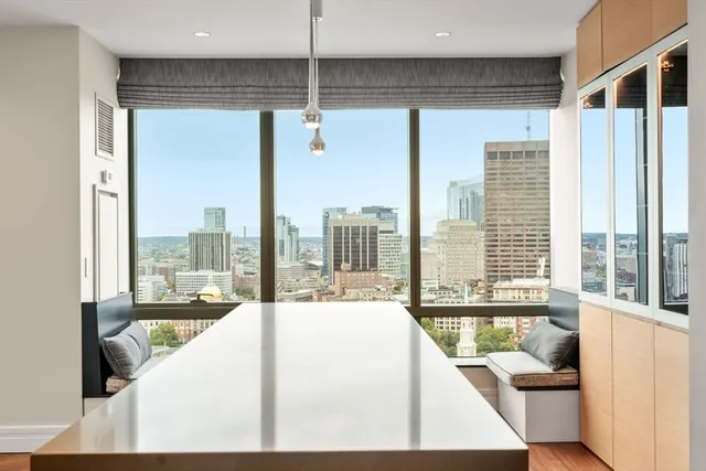 a living room with a large window and a bed