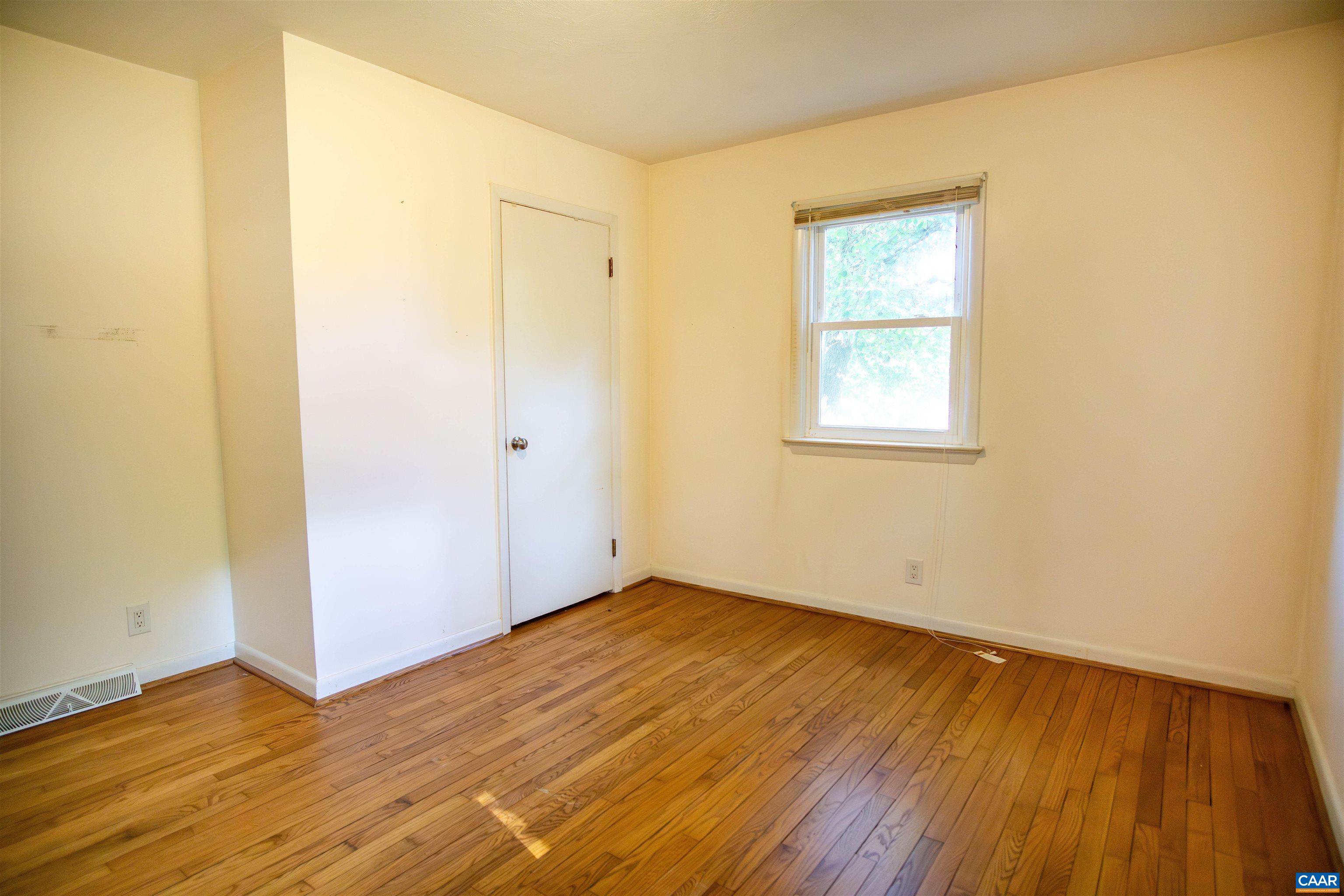 208 Locust Lane Ruckersville, VA 22968 - Photo 13 of 24 an empty room with wooden floor and windows