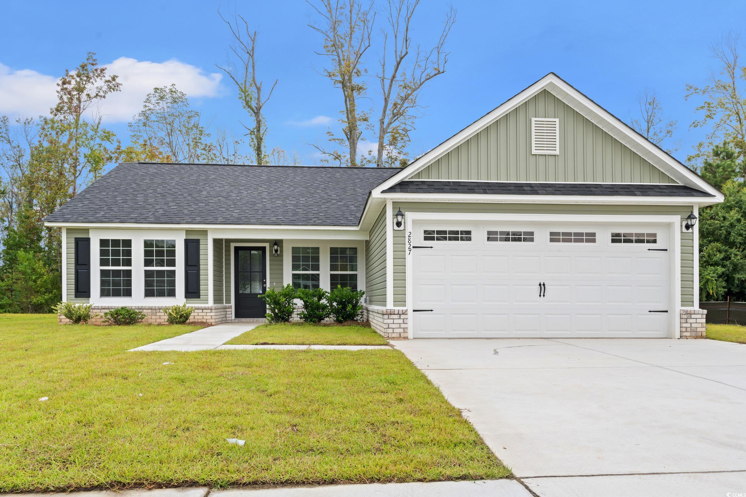 2827 Biscane Court Conway, SC 29527 - Photo 1 of 31 View of front facade featuring board and batten siding, a shingled roof, a front lawn, and driveway