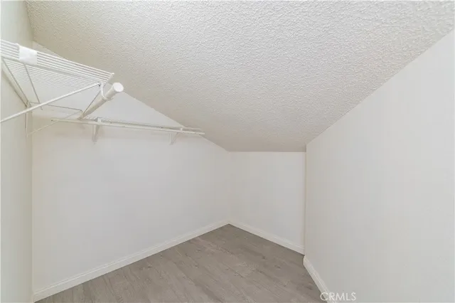 a view of a kitchen with a sink and a refrigerator