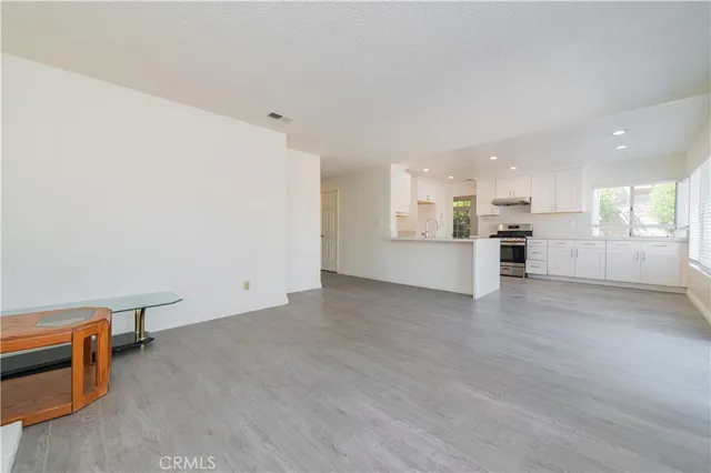 a kitchen with stainless steel appliances a sink stove and cabinets