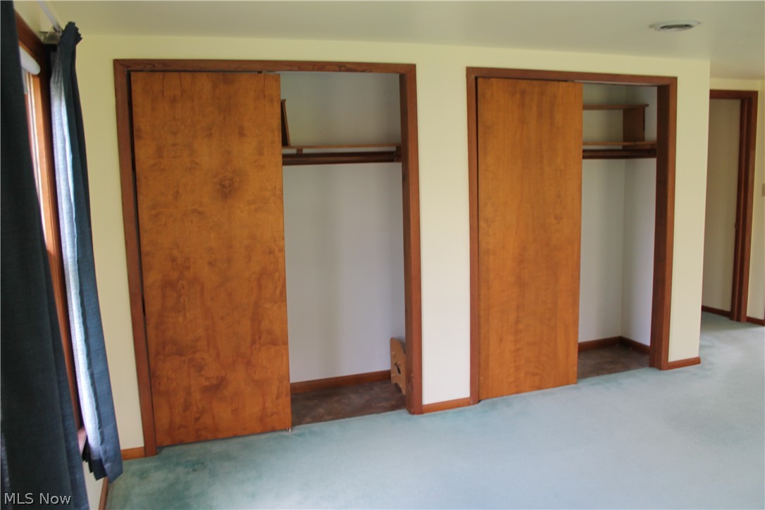 14863 Turney Road Maple Heights, OH 44137 - Photo 26 of 34 Master bedroom featuring multiple closets and carpet