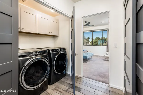 a bedroom with a large bed and a window