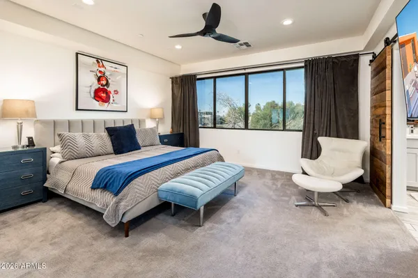 a bedroom with a large bed and a large window