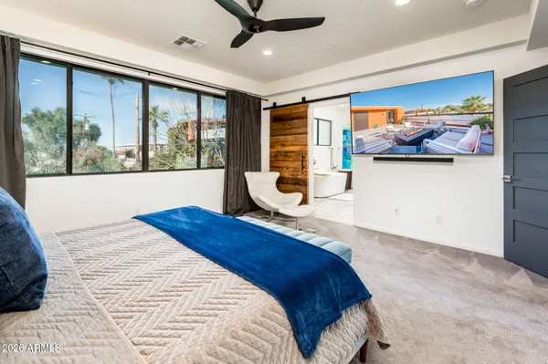 a large white kitchen with a sink window and cabinets