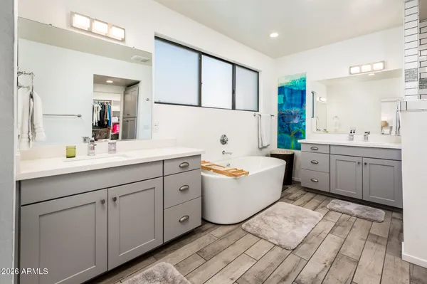 a bathroom with a sink a shower and a mirror