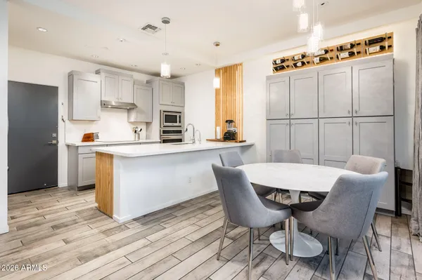 a kitchen with a refrigerator sink and white cabinets