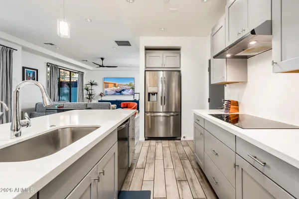 a large white kitchen with a large window