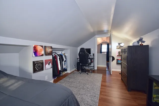 a view of a livingroom with wooden floor and furniture