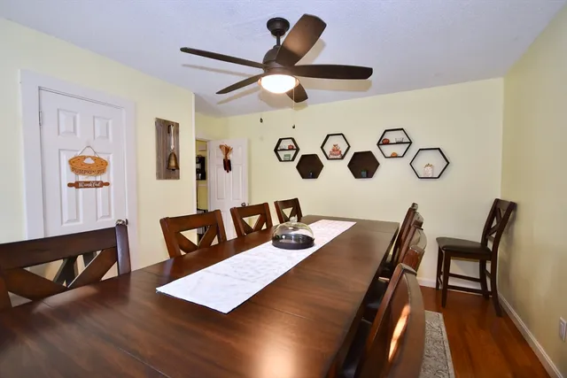 a view of a workspace with furniture and wooden floor