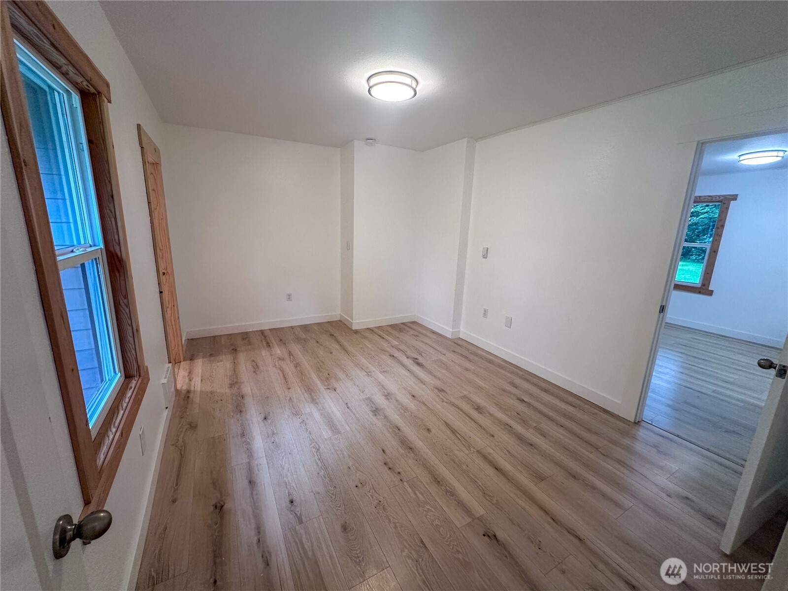 10341 184th Avenue Southwest Rochester, WA 98579 - Photo 7 of 36 wooden floor in an empty room with a mirror