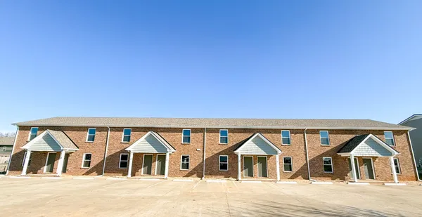 a view of houses with wooden floor and a yard