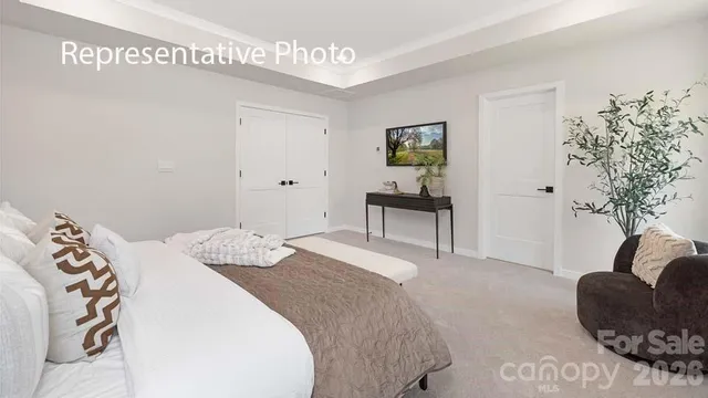 a bedroom with a bed and a potted plant