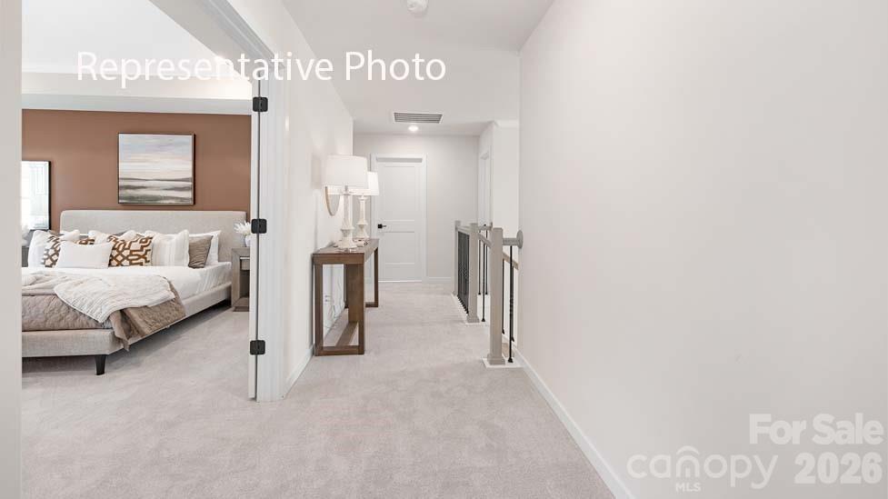 3040 Canvasback Way Indian Trail, NC 28079 - Photo 17 of 27 a bedroom with a bed and a lamp