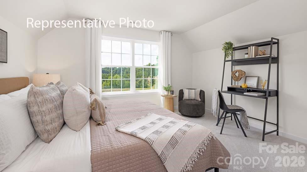 3040 Canvasback Way Indian Trail, NC 28079 - Photo 18 of 27 a bedroom with a bed a large mirror and next to a window