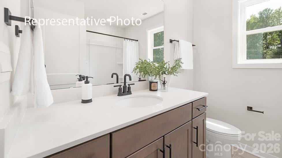 3040 Canvasback Way Indian Trail, NC 28079 - Photo 20 of 27 a bathroom with a sink a toilet and shower