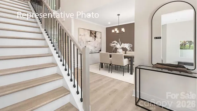 a view of a hallway with wooden floor and dining room