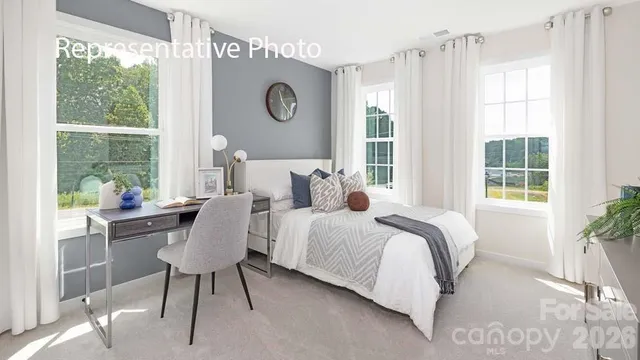 a bedroom with bed and window