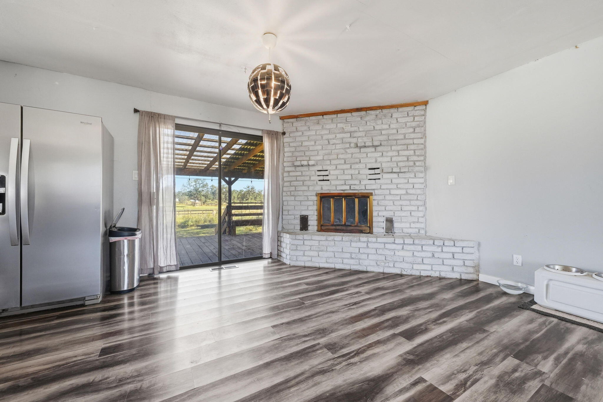 22189 Old Alturas Road Redding, CA 96003 - Photo 11 of 70 a view of empty room with wooden floor and fireplace