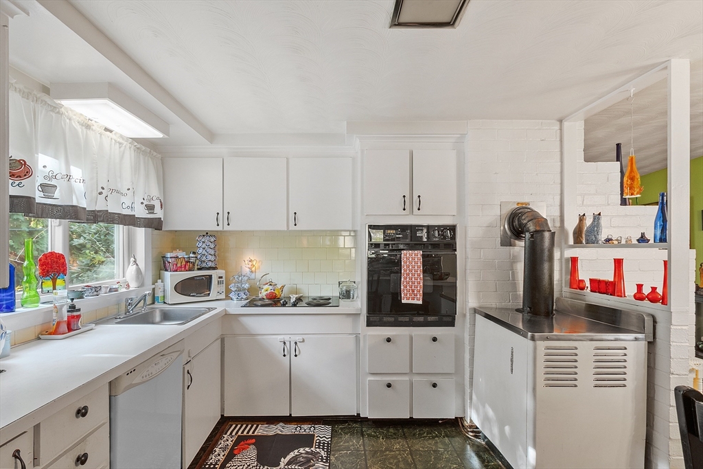 36 Brownlea Road Framingham, MA 01701 - Photo 12 of 24 a kitchen with white cabinets and white appliances