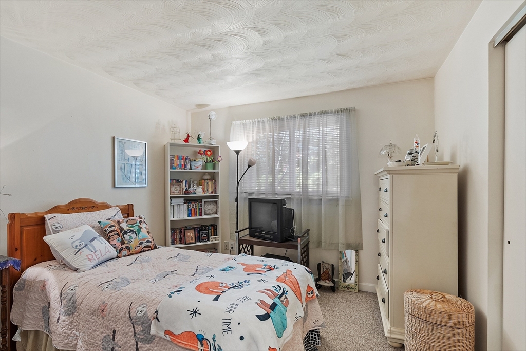 36 Brownlea Road Framingham, MA 01701 - Photo 19 of 24 a bedroom with a bed and a television