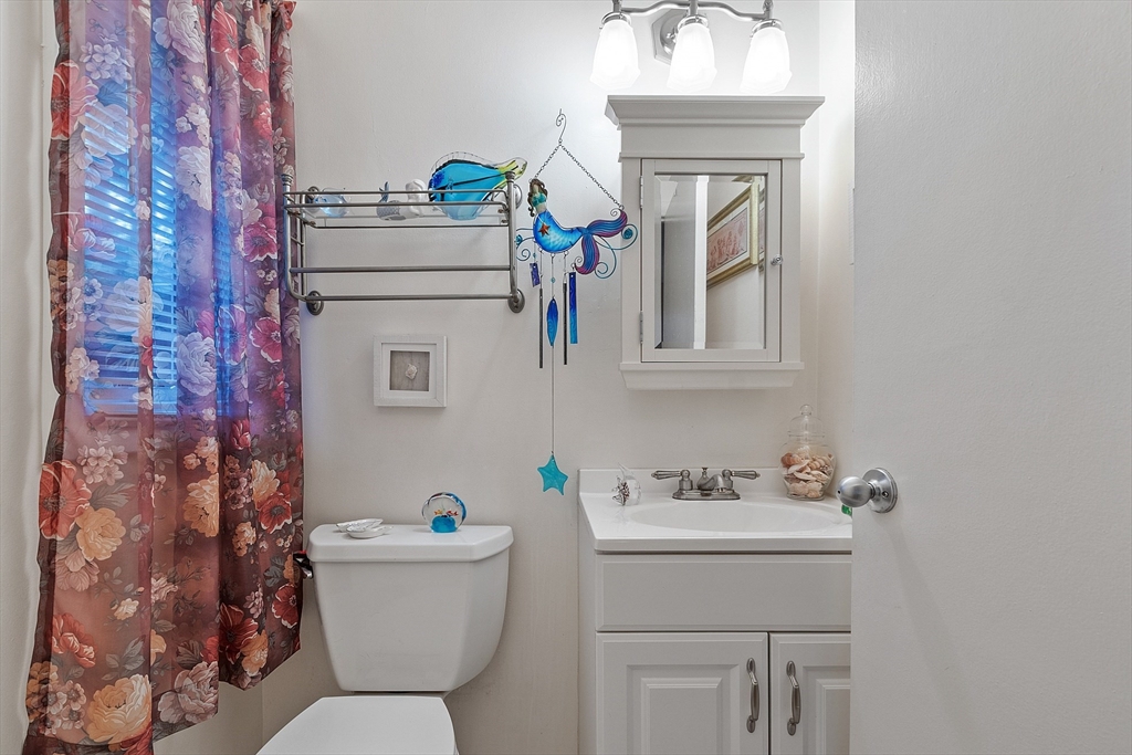 36 Brownlea Road Framingham, MA 01701 - Photo 24 of 24 a bathroom with a sink mirror vanity and toilet