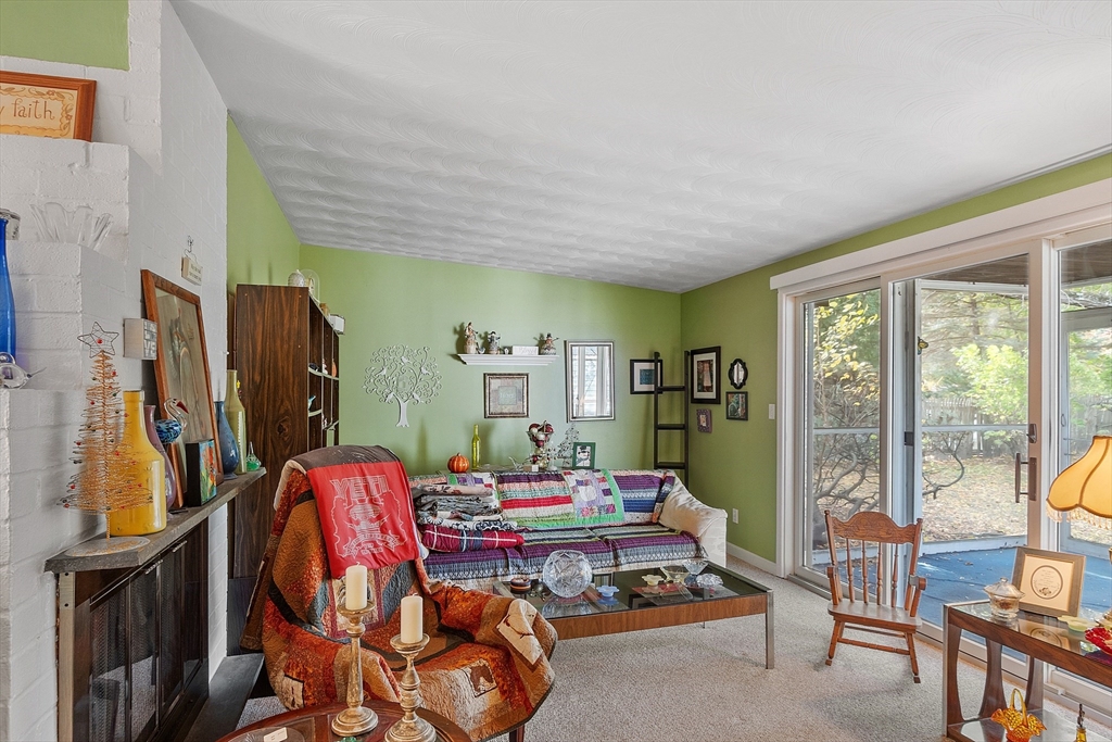 36 Brownlea Road Framingham, MA 01701 - Photo 9 of 24 a living room with furniture a flat screen tv and a floor to ceiling window