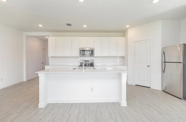 a view of a kitchen with a sink and a stove top oven